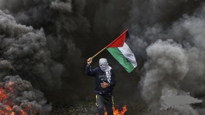 Pemuda-Palestina-membakar-ban-selama-protes-di-dekat-perbatasan-Israel-Gaza